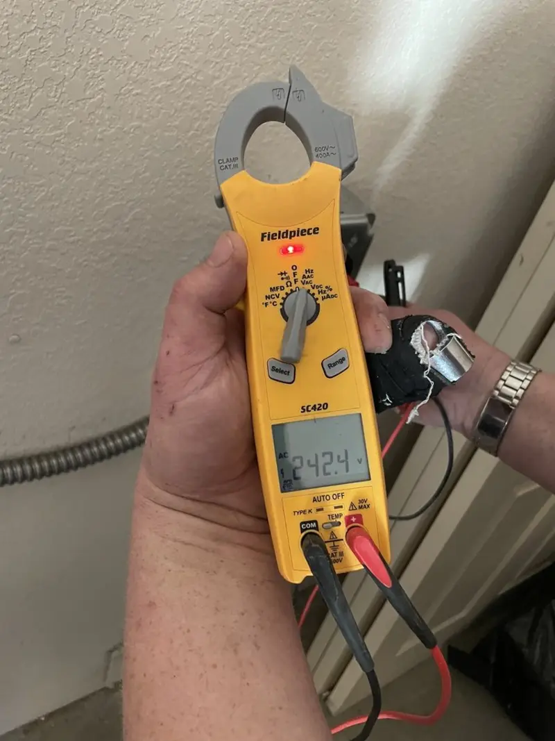 Voltage testing with clamp meter during Ceiling Fan Installation in North Vernon